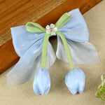 Blue Floral Charm Bow Hair Clip, laid flat