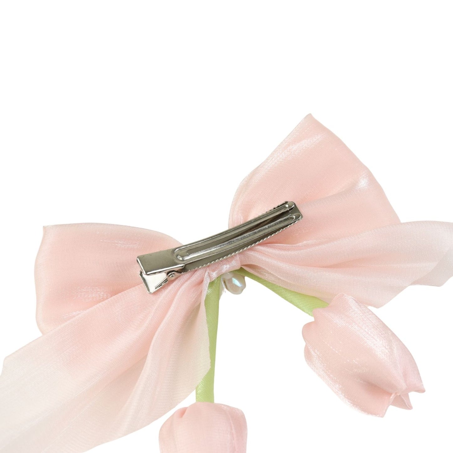 Close-up of the floral charm on the bow on the pink clip