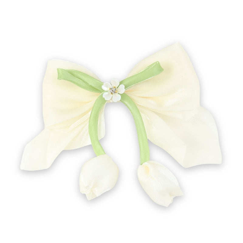 White Floral Charm Bow Hair Clip worn in hair, showing the floral charm on the bow