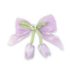 Purple Floral Charm Bow Hair Clip worn in hair, showing the floral charm on the bow