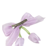 Close-up of the floral charm on the bow on the purple clip