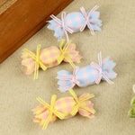 Set of 4 Blue and Yellow Fabric Candy Hair Clips, laid flat