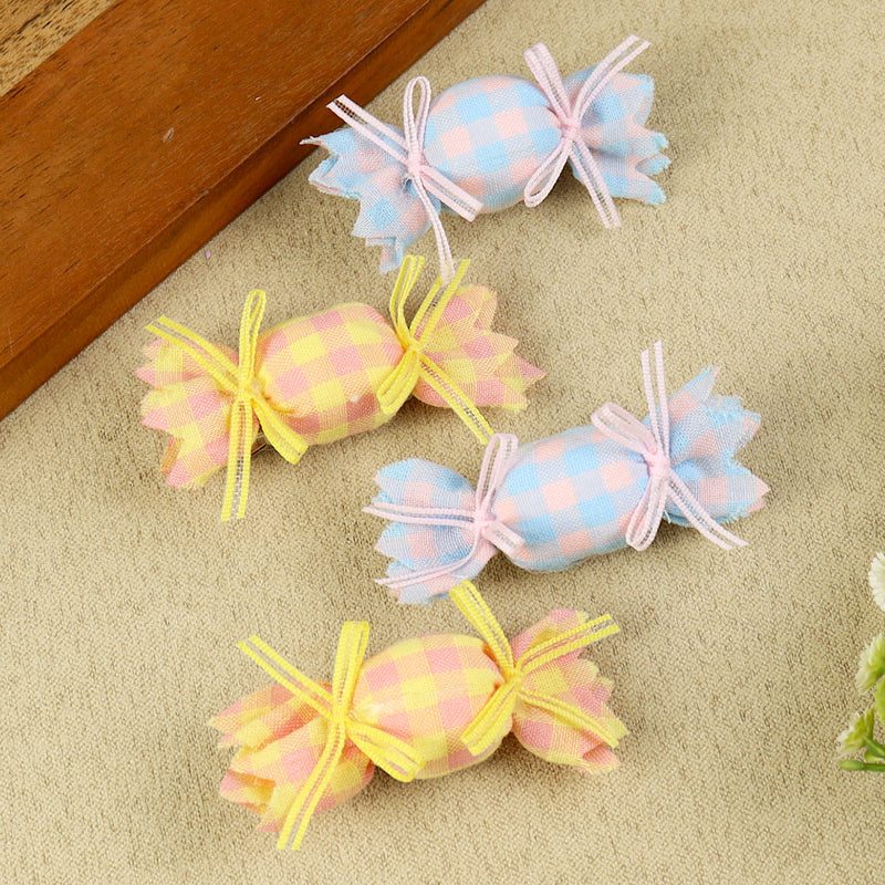 Set of 4 Blue and Yellow Fabric Candy Hair Clips, laid flat