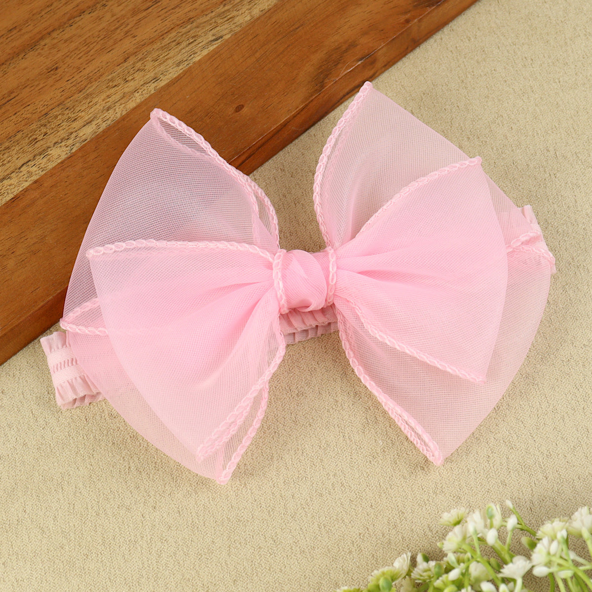 soft, stretchable elastic headband featuring pastel flowers.