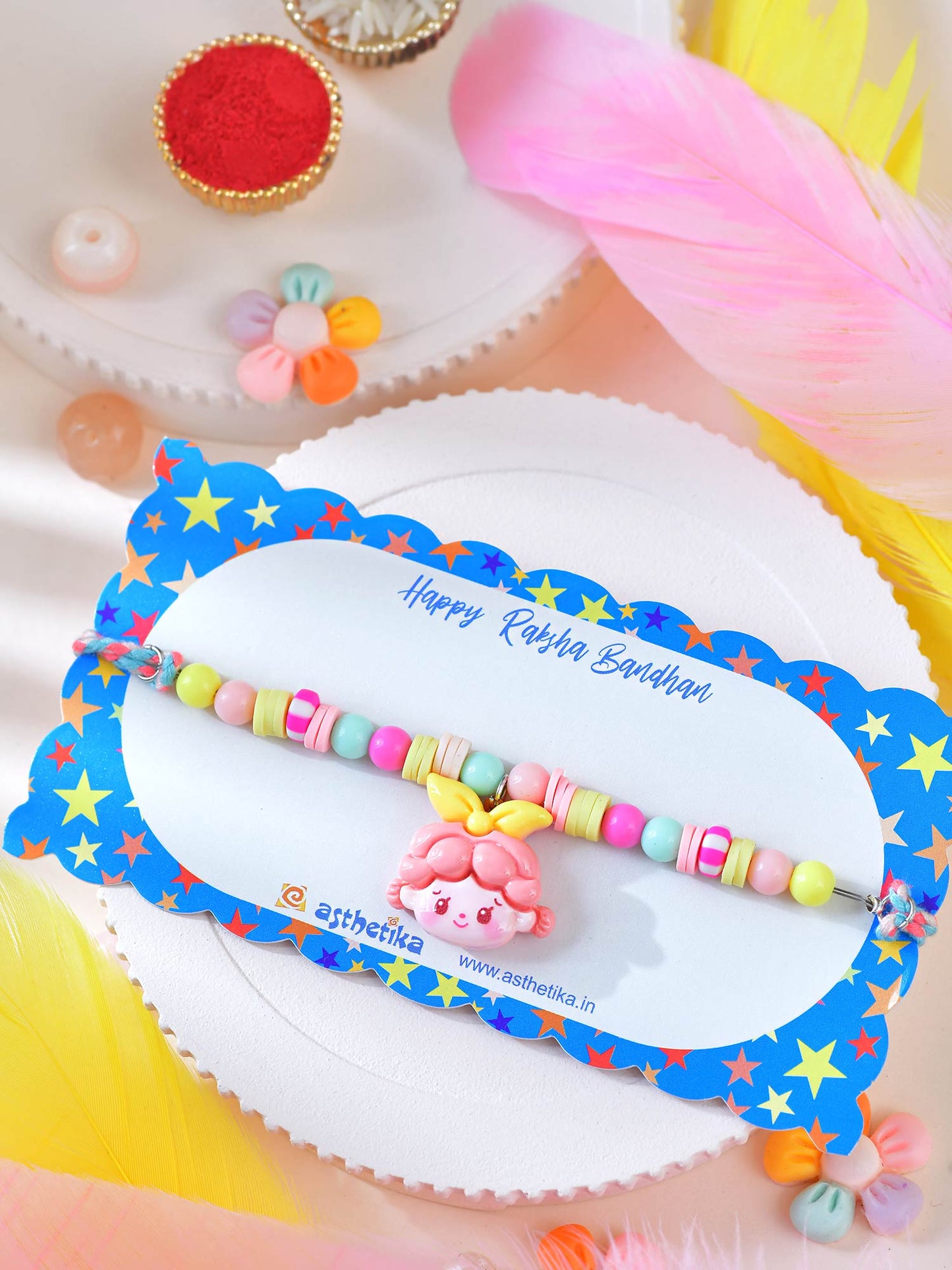 Asthetika doll charm beaded Rakhi in packaging