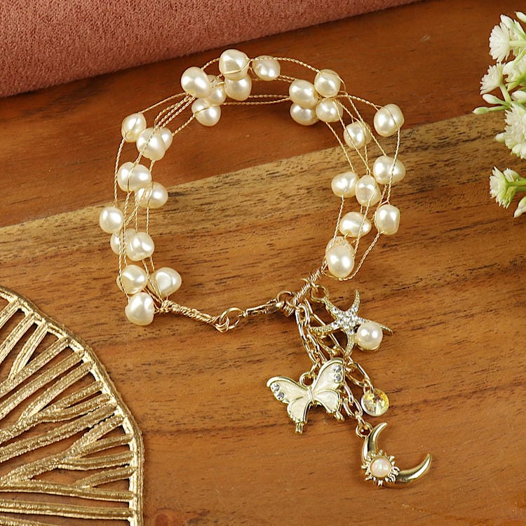 Handbeaded Pearl Butterfly Charm bracelet, laid flat