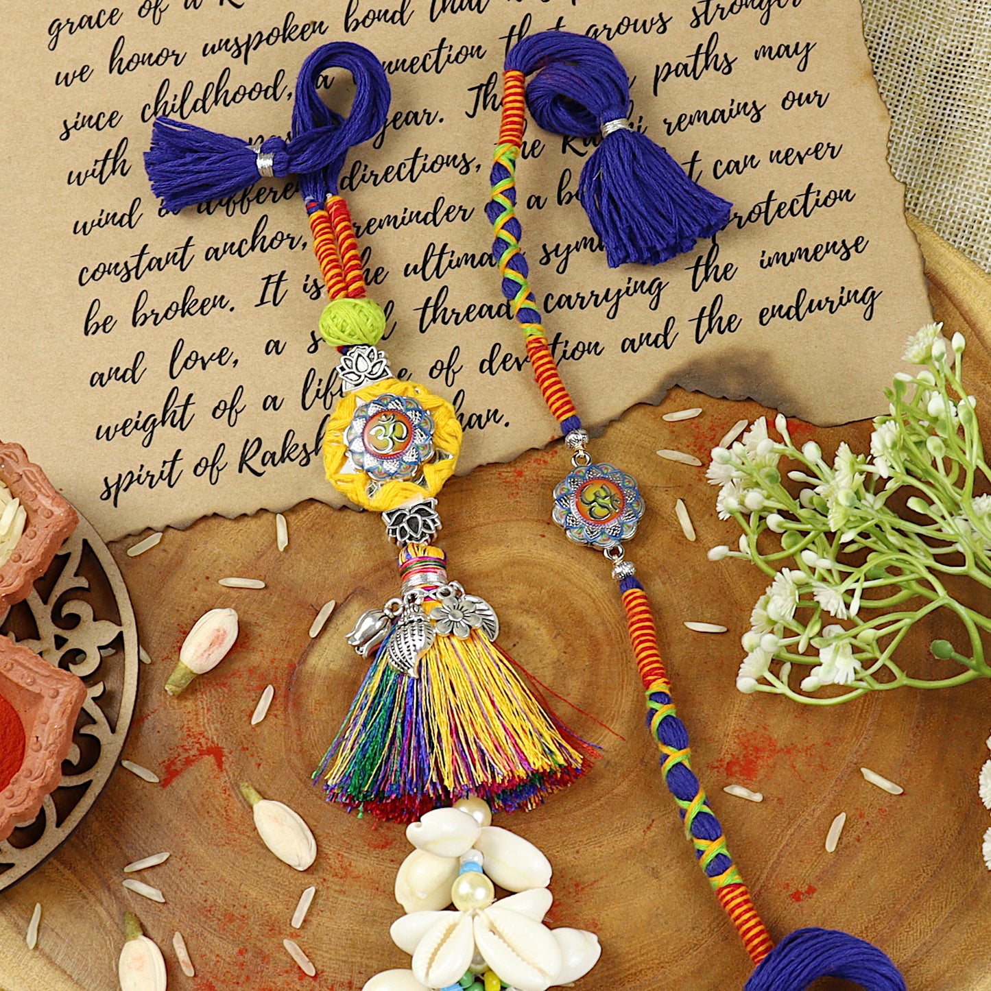 Om Tassel Bhai Bhabhi Rakhi pair — Rakhi and Lumba laid flat
