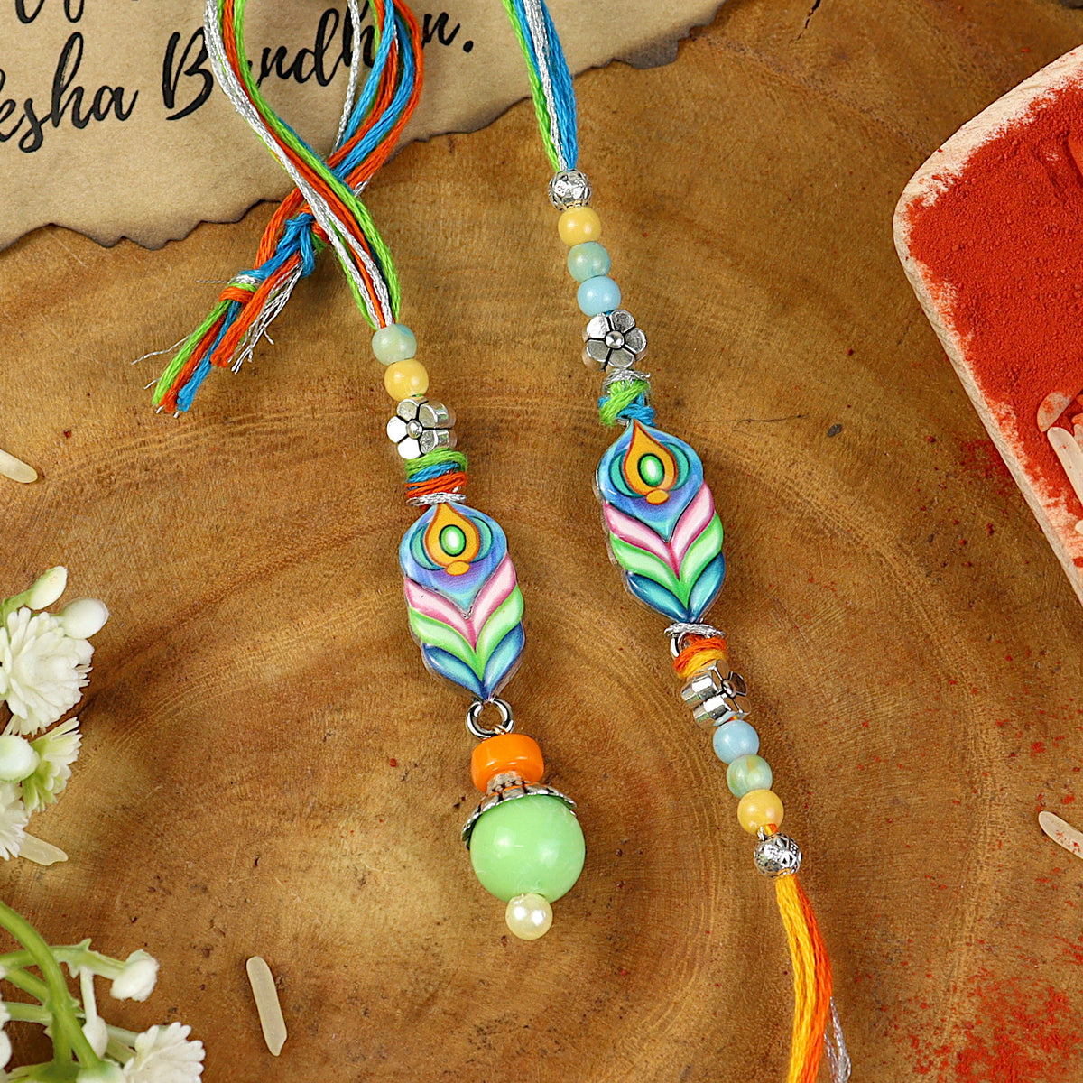 Mor Pankh Enamel Bhai Bhabhi Rakhi pair — Rakhi and Lumba laid flat
