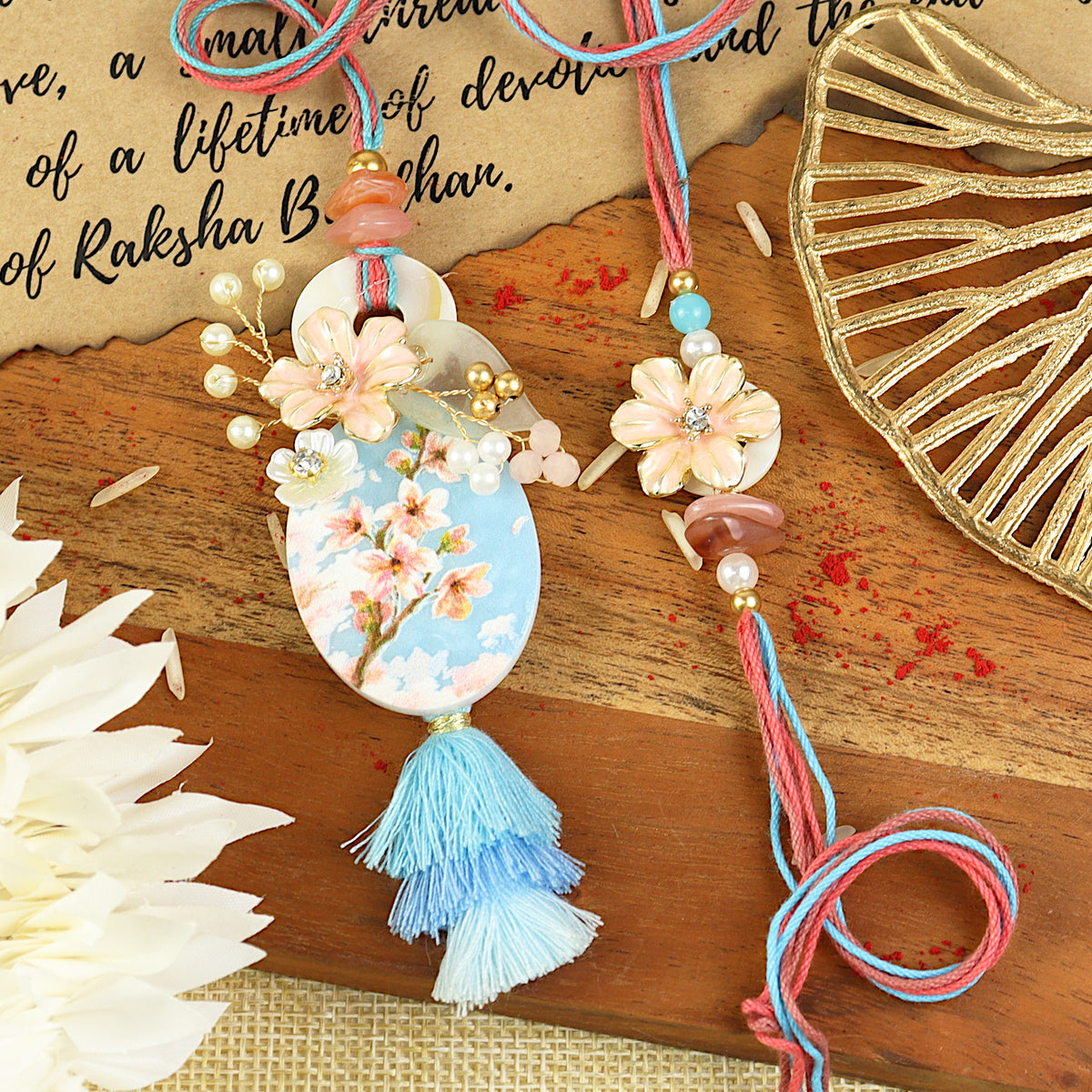 Floral Printed Motif Bhai Bhabhi Rakhi pair — Rakhi and Lumba laid flat