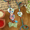 Bohemian Floral Print Frosted Leaf Bhai Bhabhi Rakhi pair — Rakhi and Lumba laid flat