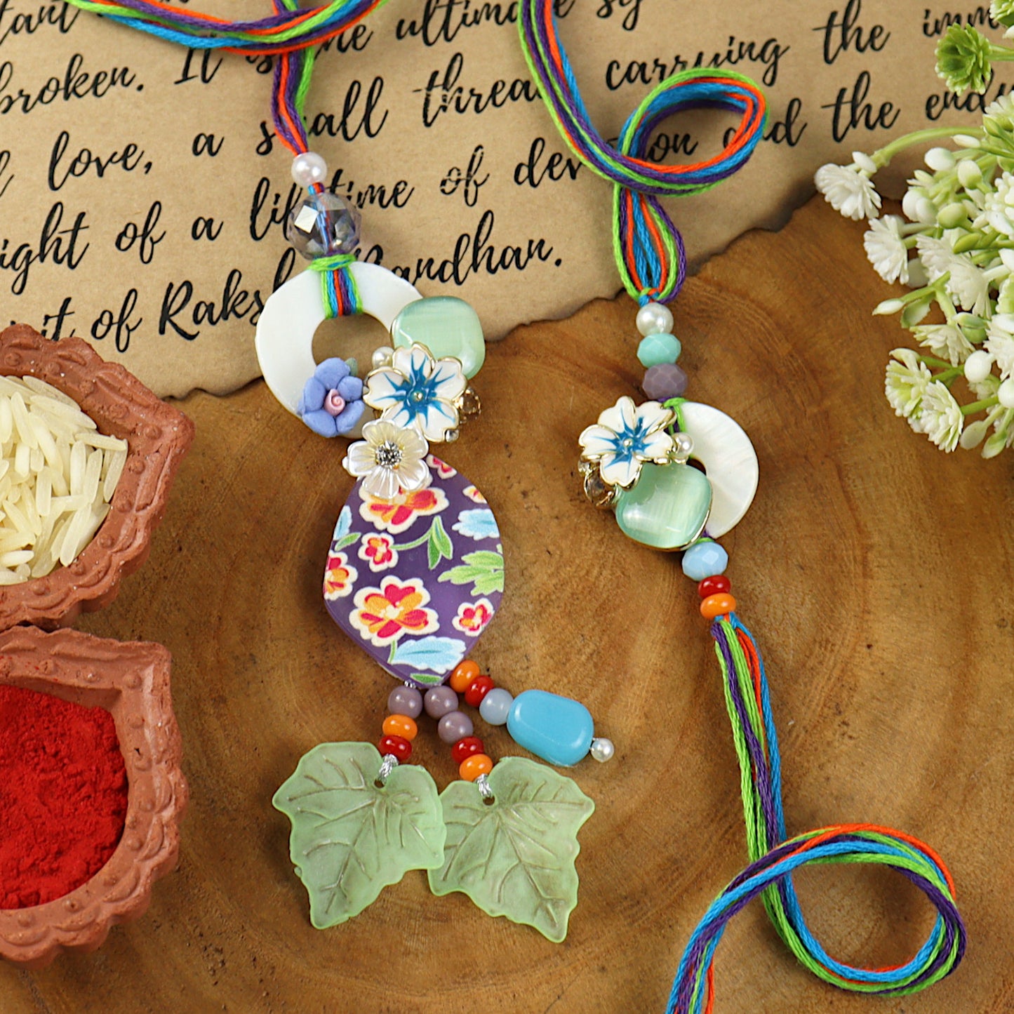 Bohemian Floral Print Frosted Leaf Bhai Bhabhi Rakhi pair — Rakhi and Lumba laid flat