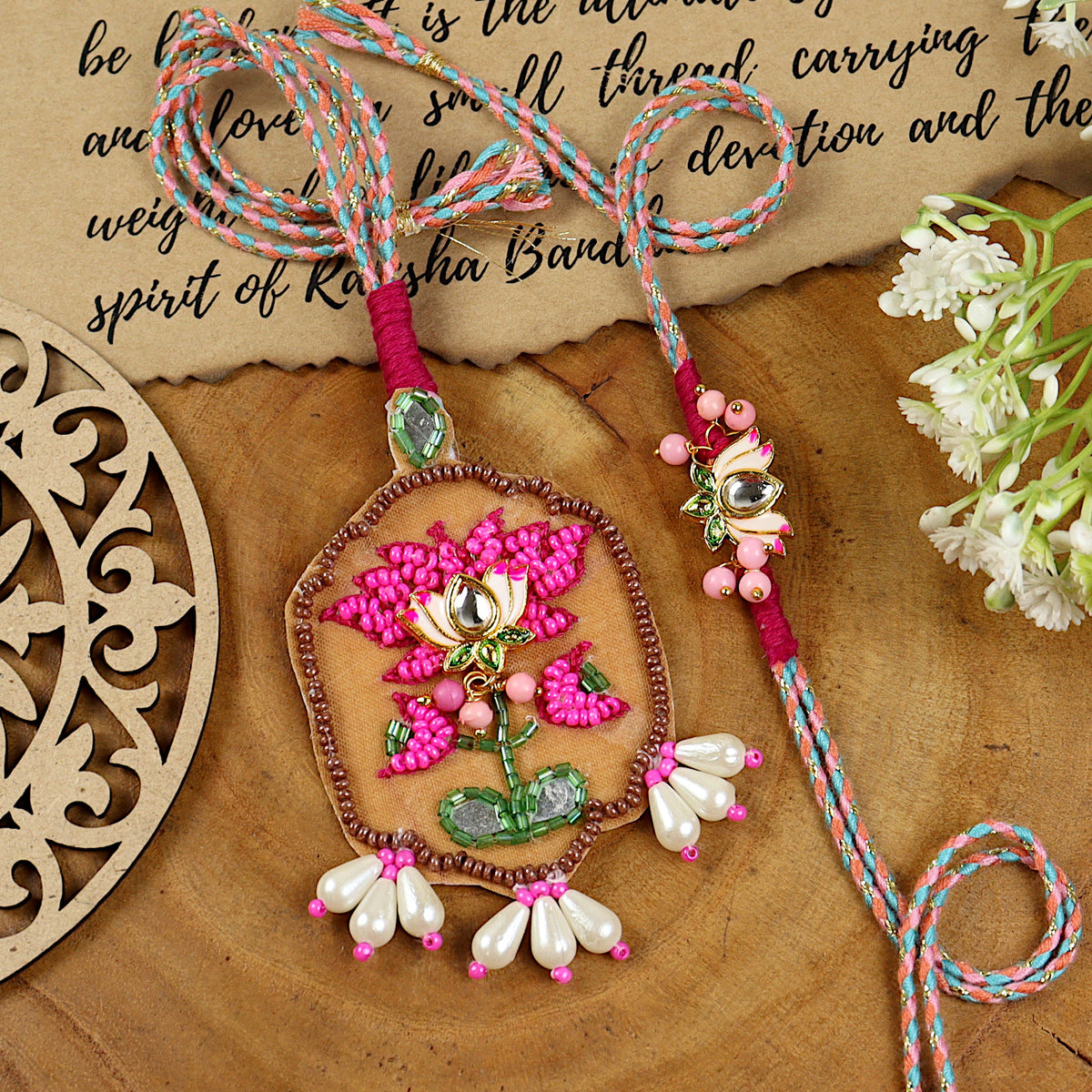 Hand Embroidered Lotus Bhai Bhabhi Rakhi pair — Rakhi and Lumba laid flat