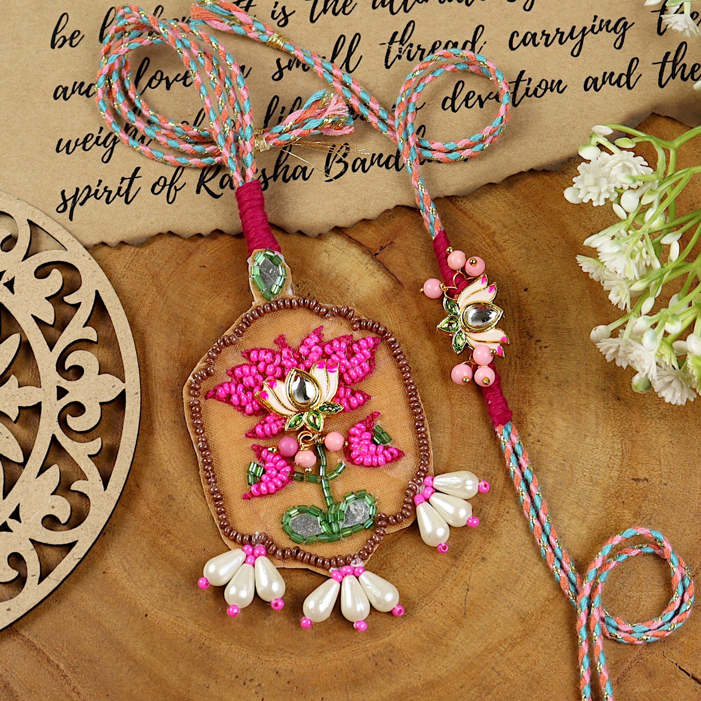 Hand Embroidered Lotus Bhai Bhabhi Rakhi pair — Rakhi and Lumba laid flat