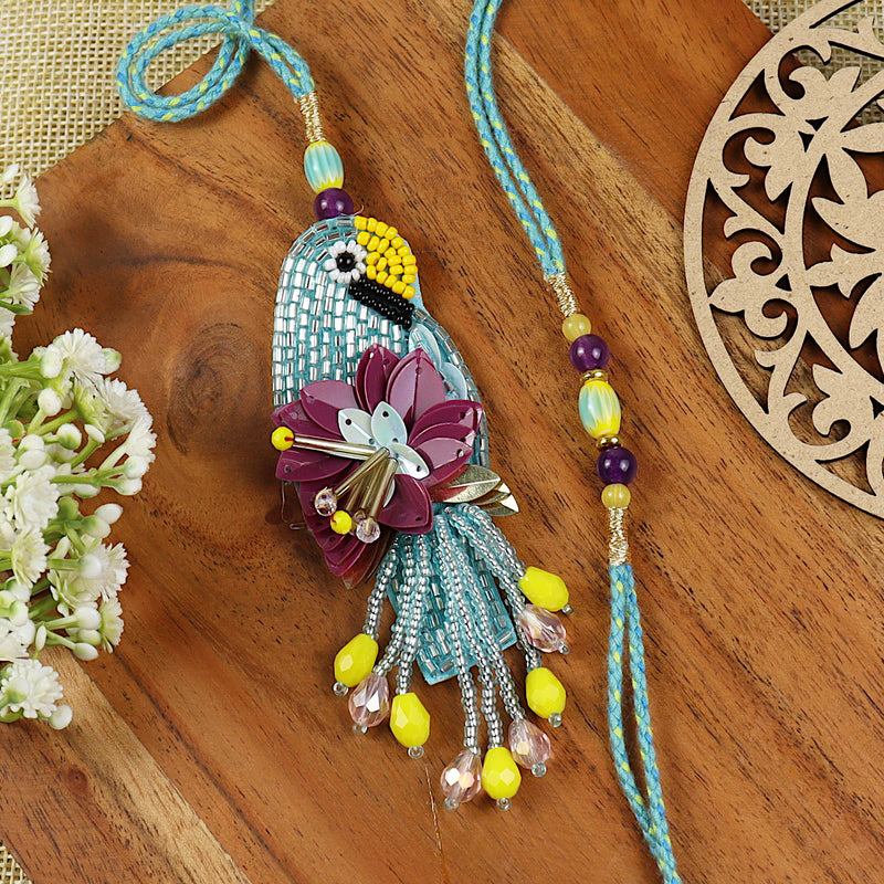 Hand Embroidered Parrot Bhai Bhabhi Rakhi pair — Rakhi and Lumba laid flat