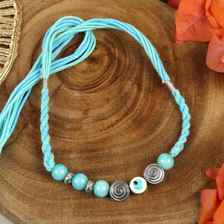 Turquoise Stone Healing Rakhi Packed in a Features Card