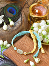 Zircon-studded stone Rakhi on a thread cord