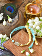 Zircon-studded stone Rakhi on a thread cord