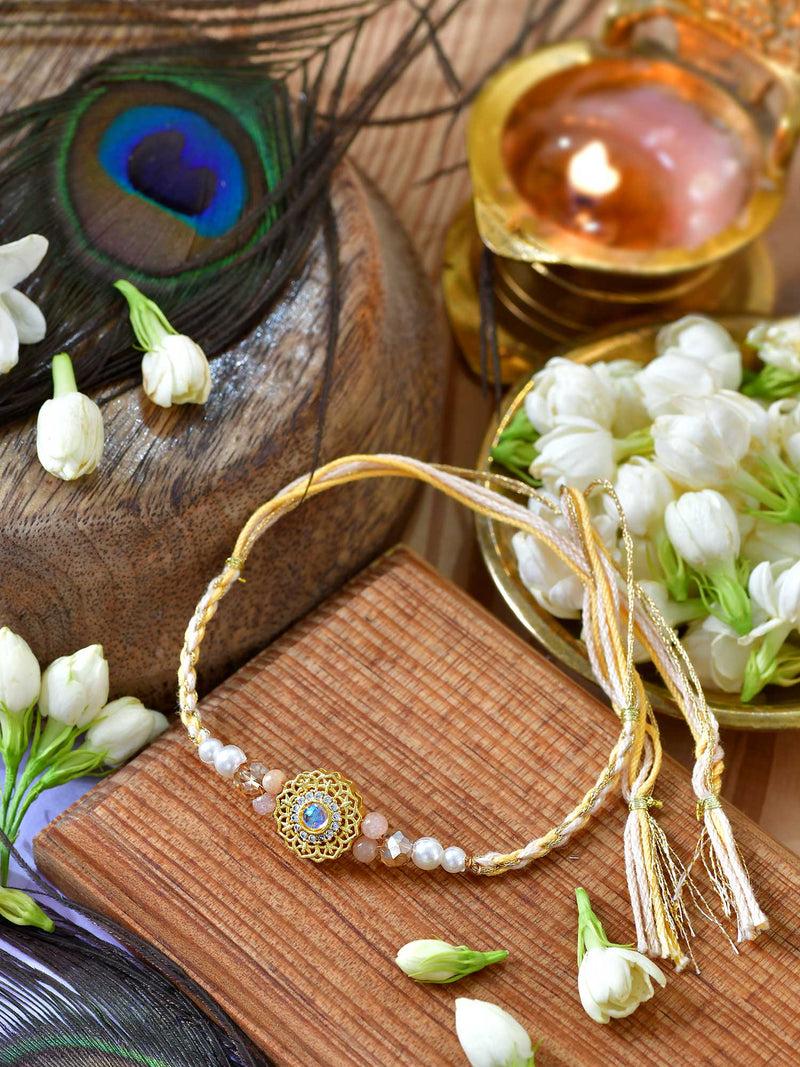 Zircon-studded Rakhi with zircon detailing on a thread cord
