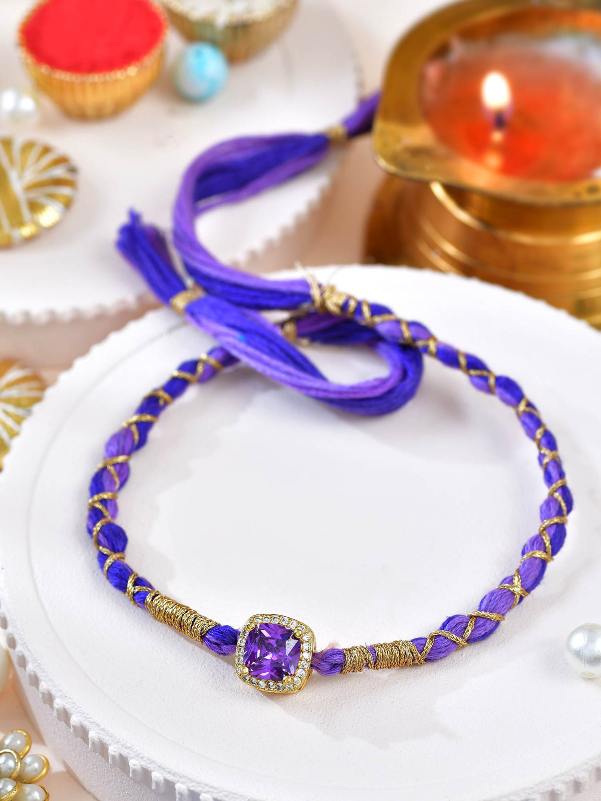 Amethyst zircon stone Rakhi with amethyst and zircon detailing on a cord