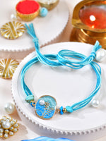 Floral stone Rakhi with floral stone motif on a thread cord