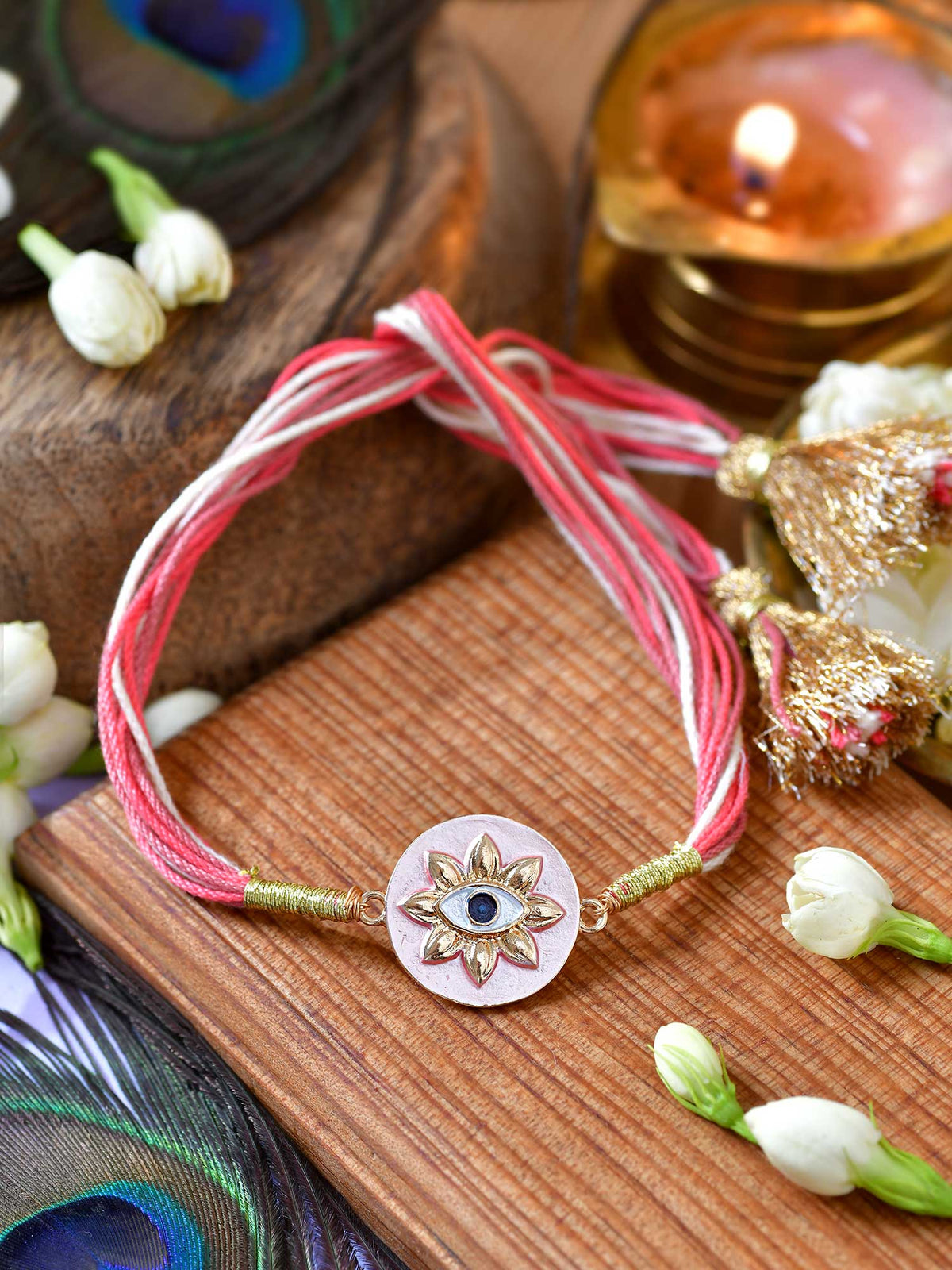Evil Eye Tassel Rakhi with Evil Eye charm and fancy tassel on a thread cord