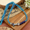 Lapis Lazuli Hamsa Evil Eye Rakhi in lapis lazuli, laid flat