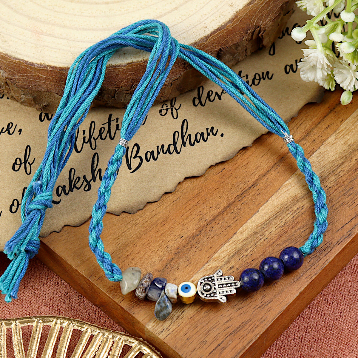 Lapis Lazuli Hamsa Evil Eye Rakhi in lapis lazuli, laid flat