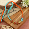 Red Jasper Buddha Rakhi in red jasper, laid flat