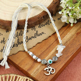 Moonstone Om Rakhi in moonstone, laid flat