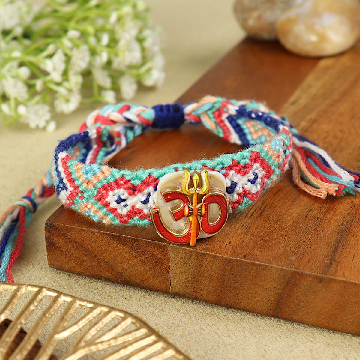 Handwoven Om Bracelet Rakhi, laid flat