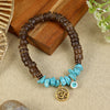 Coconut Shell Turquoise Om Bracelet Rakhi, laid flat