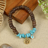 Coconut Shell Turquoise Om Bracelet Rakhi, laid flat