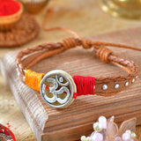 Metal Om Leather Bracelet Rakhi, laid flat