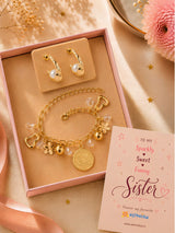 Pearls and hanging charms bracelet and earrings set, laid flat