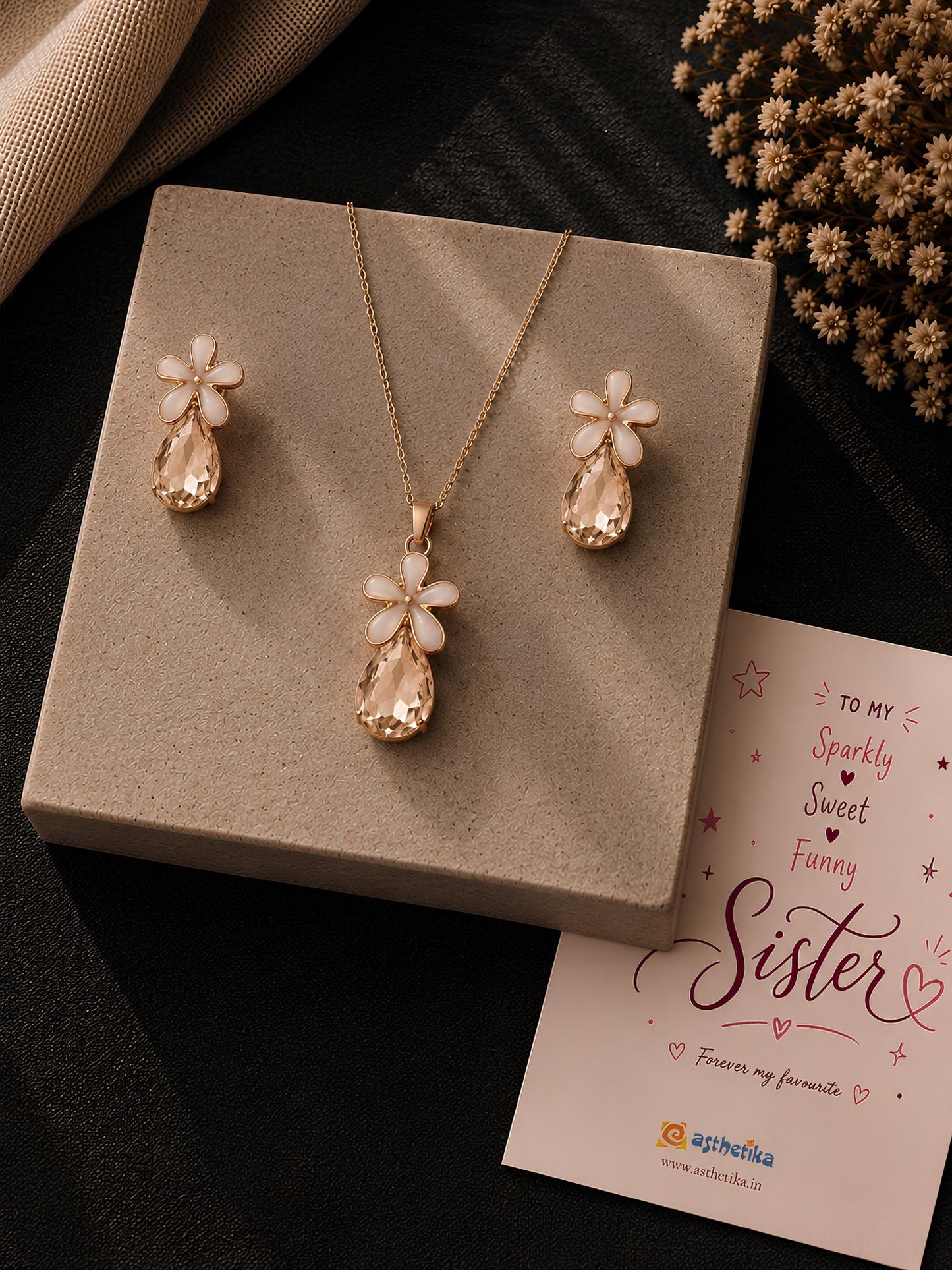 Crystal floral teardrop necklace and earrings set, laid flat