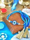 Evil Eye Stone Tassel Rakhi with Evil Eye charm and tassel on a thread cord