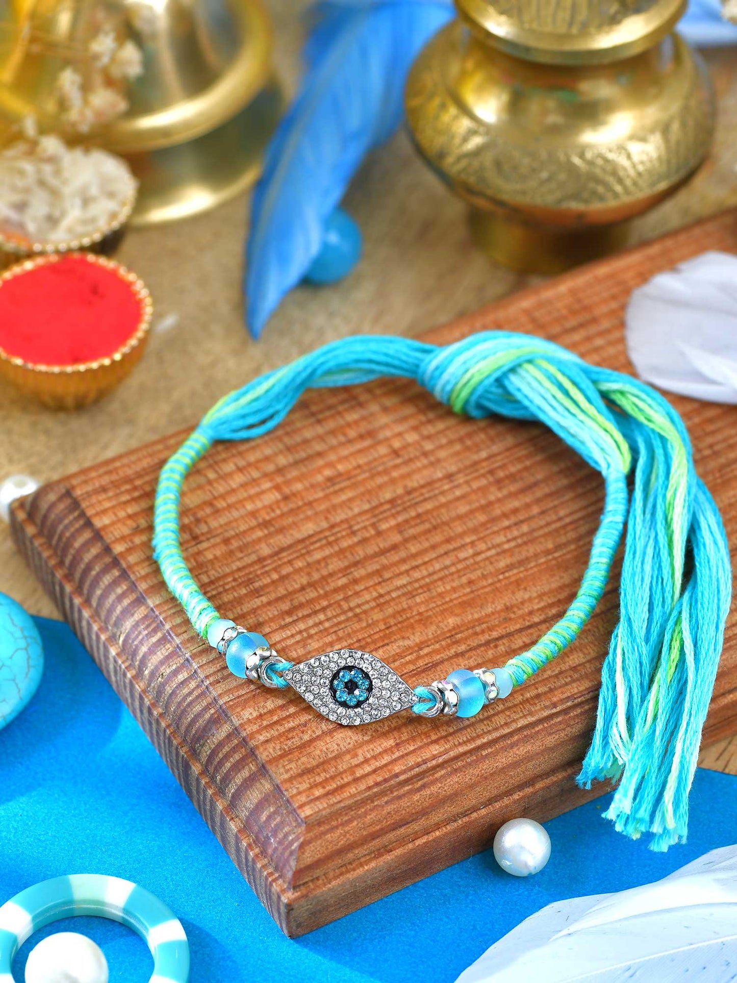 Diamond stone Evil Eye Rakhi with diamond stone Evil Eye charm on a thread cord