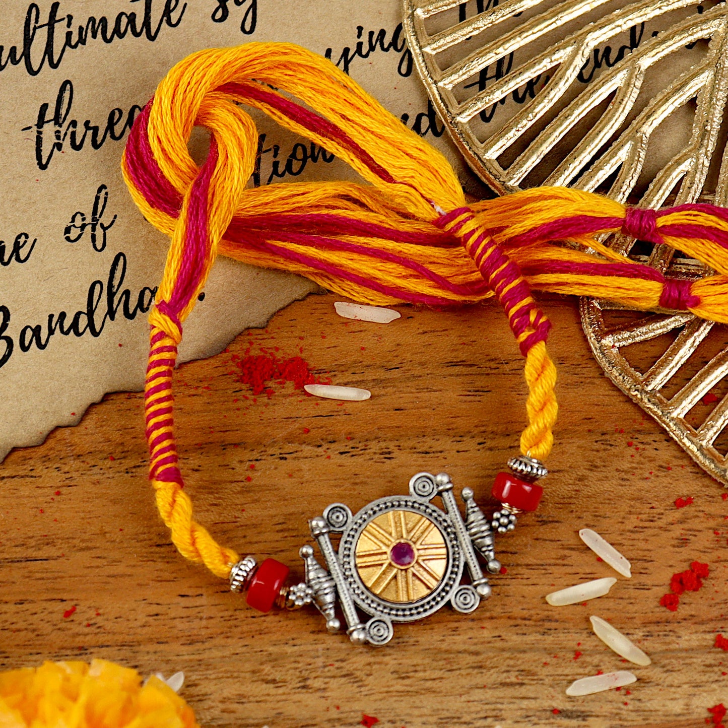 Oxidised Gold Ruby Rakhi, laid flat