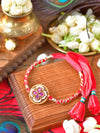 Ruby stone Rakhi with ruby stone setting on a thread cord