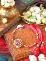 Ruby stone Rakhi with ruby stone setting on a thread cord