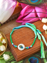 Peacock stone Rakhi with peacock stone motif on a thread cord