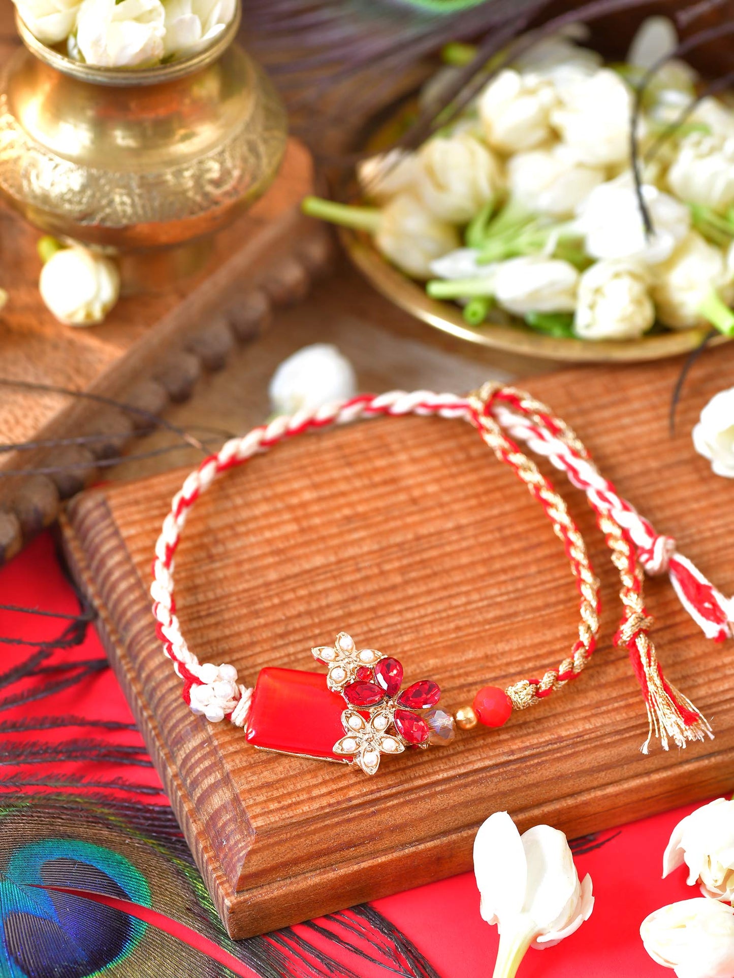 Floral stone charm Rakhi with floral stone motif on a thread cord