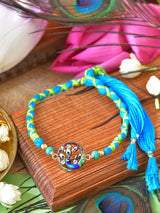 Peacock weaved thread Rakhi with peacock stone on a weaved thread cord
