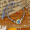 Peacock Printed Thread Rakhi, laid flat
