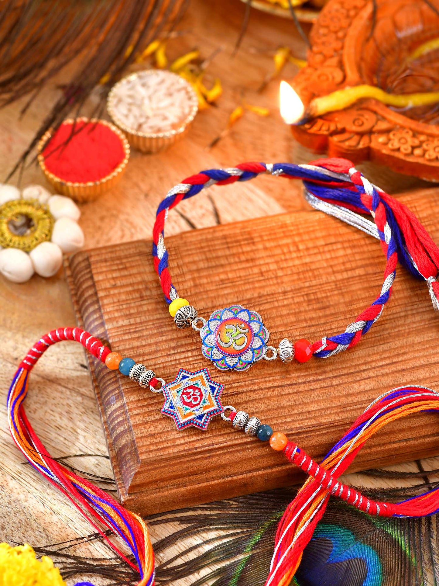 Om charm Rakhis set of 2 with Om charms on thread cords