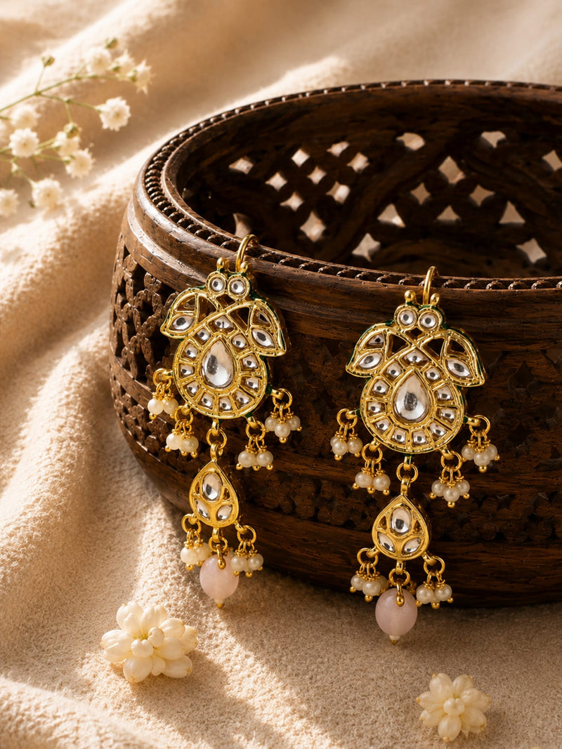 Paisley Kundan earrings with soft pink stone and pearl beads, gold-toned, laid flat