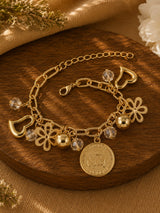 Multi charm beaded gold tone bracelet on an adjustable chain, laid flat