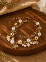 Multi charm gold tone beaded bracelet on an adjustable chain, laid flat