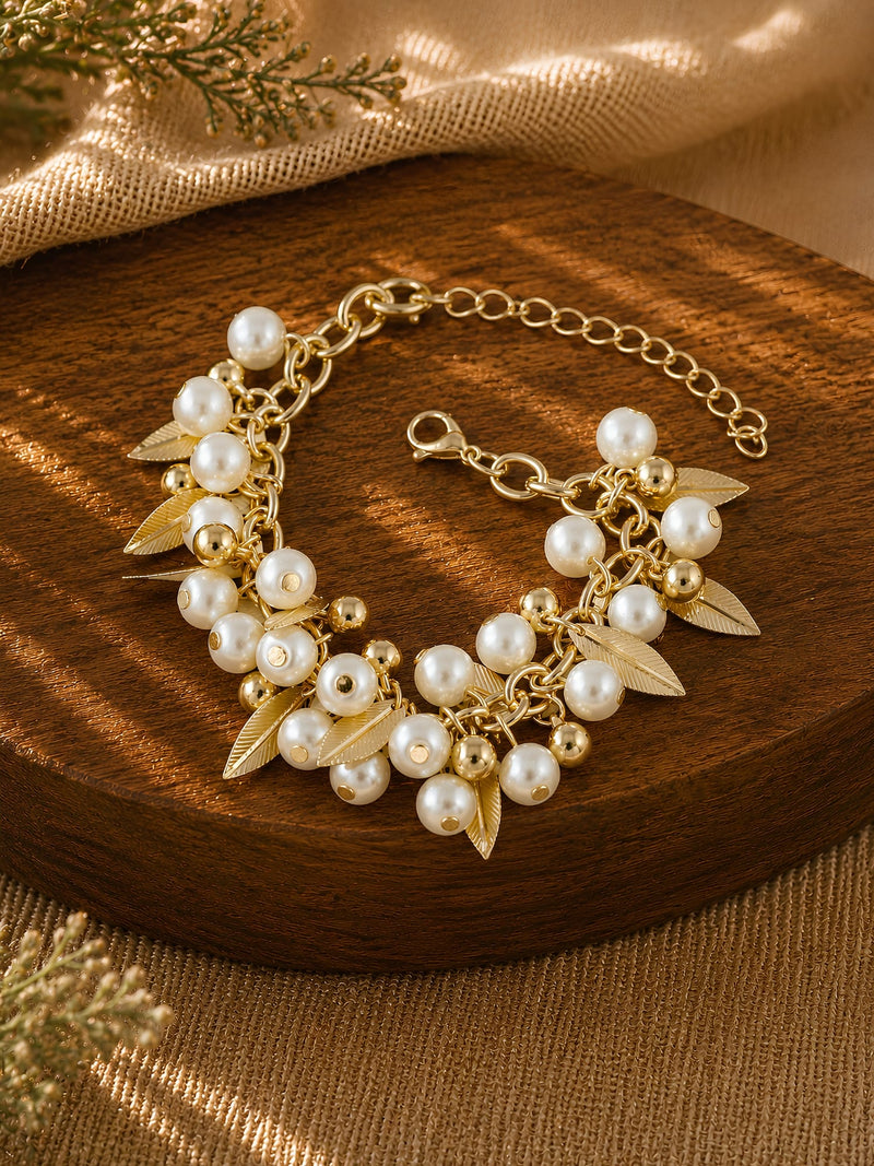 Gold tone leaves and beads chain bracelet on an adjustable chain, laid flat