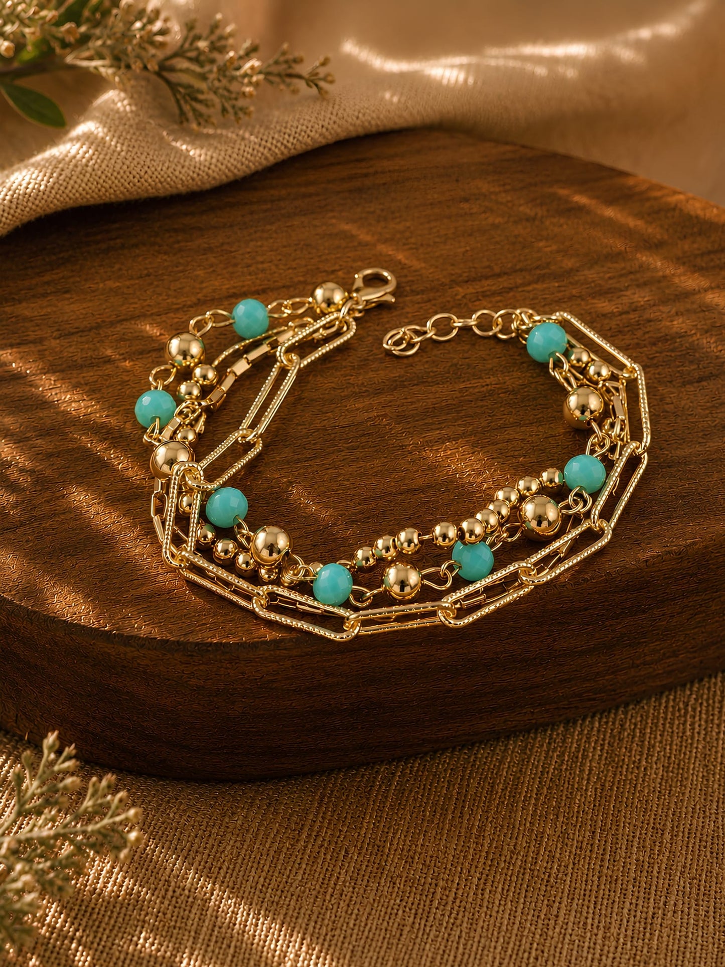 Gold tone chain beaded bracelet on an adjustable chain, laid flat